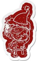 cartoon distressed sticker of a happy spacegirl holding moon rock wearing santa hat vector