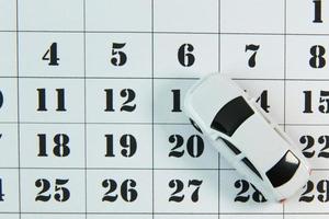 The white car on calendar background image close up. photo