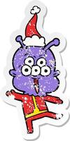 happy distressed sticker cartoon of a alien dancing wearing santa hat vector