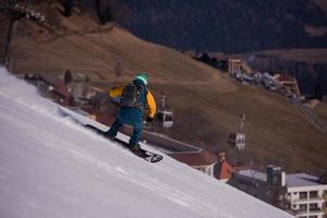 snowboarder running down the slope and ride free style photo