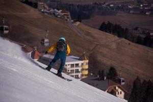 snowboarder running down the slope and ride free style photo