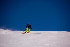 Skier having fun while running downhill photo