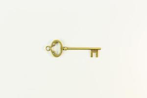 vintage gold key on white background. photo