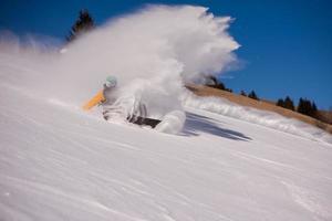 snowboarder crashes while carving down photo