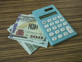 The banknote and calculator on wood table for business content. photo
