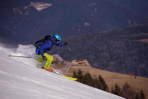 Skier having fun while running downhill photo