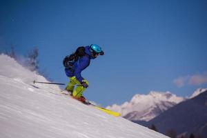 Skier having fun while running downhill photo