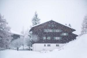 casa de montaña en tormenta de nieve foto