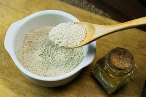 white Sesame seeds  on a old wooden table. photo