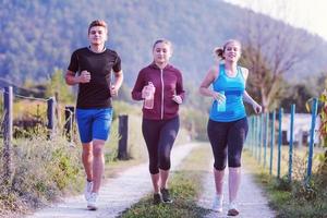 young people jogging on country road photo