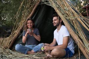 couple spending time together in straw tent photo