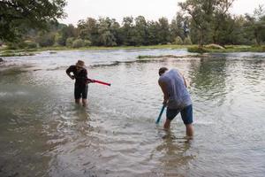 young men having fun with water guns photo