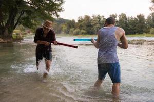 young men having fun with water guns photo