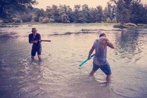 young men having fun with water guns photo