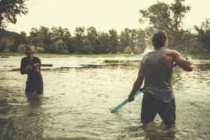 young men having fun with water guns photo