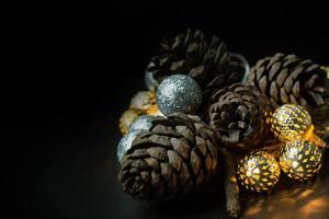 The christmas ball and Pine cones  on black  background. photo