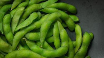 Edamame  in black plate top view image for food content. photo