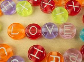 The love word on alphabet bead multi color for background content photo