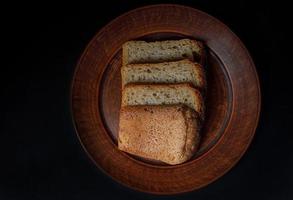 Sliced pieces of bread close-up on a ceramic plate. Sourdough bread. photo