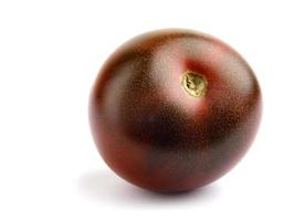 Ripe tomato cherri cumato close-up isolated on a white background. Black tomato. photo