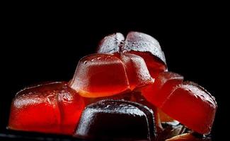 Very beautiful marmalade candy. Marmalade on a black background. photo