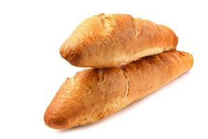Two French baguettes are isolated on a white background. photo