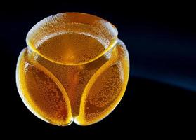 Beautiful yellow marmalade candy is isolated on a black background. photo