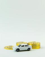 white car toy and gold coin on  white background. photo