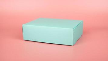 turquoise festive gift box on pink background photo