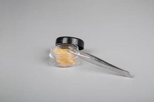 cannabis extract in container for smoking gray background photo
