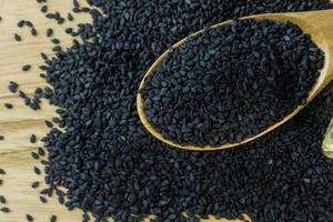 black Sesame seeds  on a old wooden table. photo