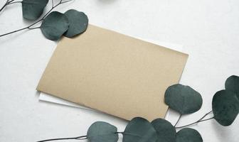 Mockup for a letter or a wedding invitation with leaves eucalyptus branches. photo