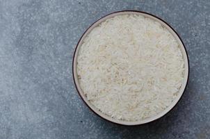 Uncooked Rice in Ceramic Bowl photo