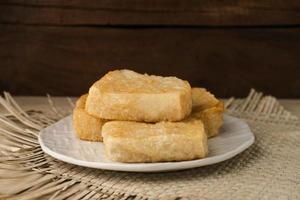 Jadah Goreng or Fried sticky rice cake is Javanese traditional cake made from glutinous rice and grated coconut. Served in white plate photo
