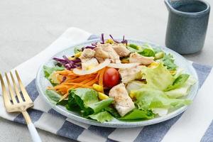 Green salad from green leaves mix vegetables, potatoes and roasted chicken with mayonnaise sauce. photo