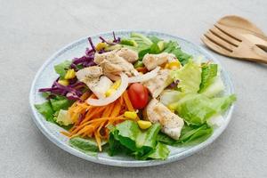 Green salad from green leaves mix vegetables, potatoes and roasted chicken with mayonnaise sauce. photo