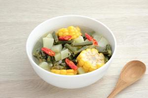 Sayur asam, sayur asem or tamarind soup is a popular traditional Indonesian soup. Common ingredients are chayote, long beans and corn with the addition of tamarind or bilimbi. Served in white bowl. photo