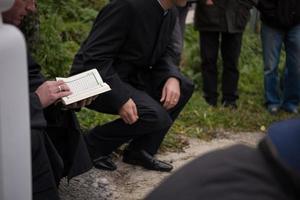 lectura del libro sagrado del corán por el imán en el funeral islámico foto