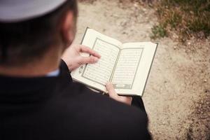 quran holy book reading by imam  on islamic funeral photo