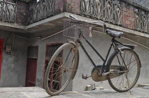 Rustic vintage bicycle in old town China photo