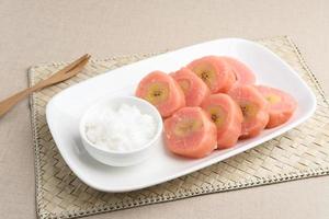 Kue Kacamata or Mata Roda is a traditional javanese snack. Bananas wrapped in cassava dough, steamed, covered with grated coconut. Similar to Sanggar Banyu, Putri Noong, Pisang Rai. photo