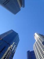 Look up to blue sky to see high rise financial buildings photo