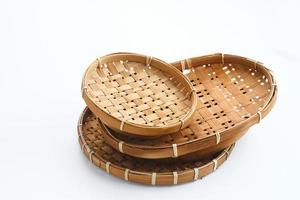 Traditional wicker plate made of bamboo isolated on a white background. Copy space. photo