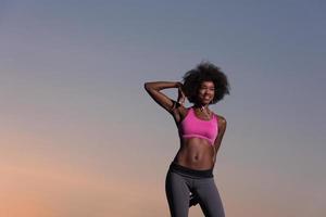 black woman is doing stretching exercise relaxing and warm up photo