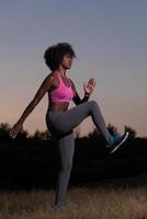 black woman is doing stretching exercise relaxing and warm up photo