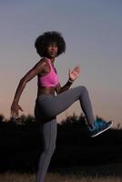 black woman is doing stretching exercise relaxing and warm up photo