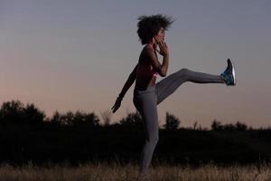 black woman is doing stretching exercise relaxing and warm up photo