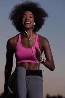 black woman is doing stretching exercise relaxing and warm up photo