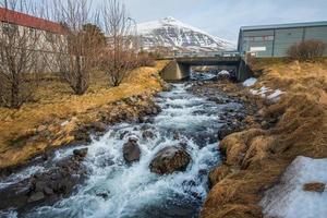 The river flowing from the mountains in Stodvarfjordur town of East Iceland. photo