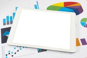 Blank white screen tablet on business graph photo